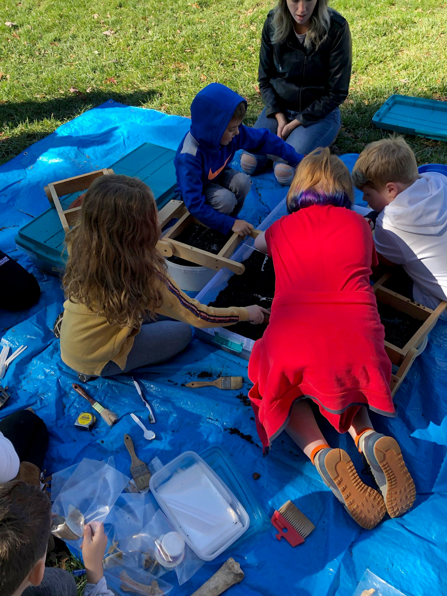 Children participating in a mock archaeology dig at Archaeology Day 2019