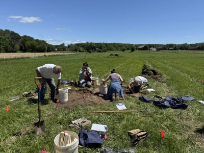 Participants in the UConn Archaeology field schoo working on a test pit l at the Hollister site in June 2025.